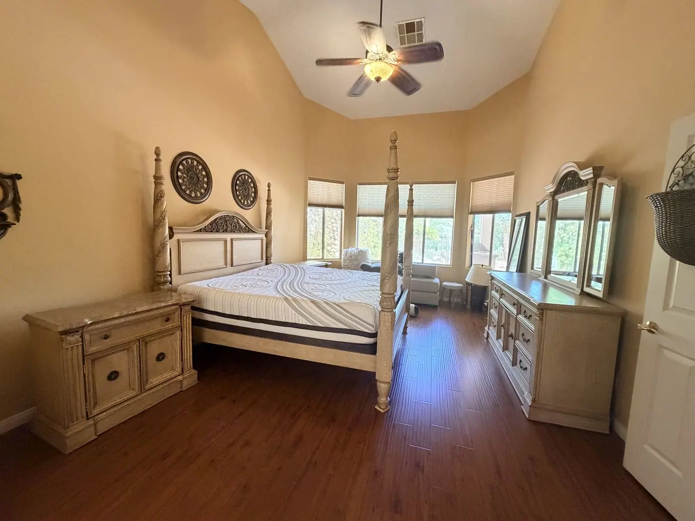 Henderson bedroom with a four-poster king bed, dresser and nightstand still in place