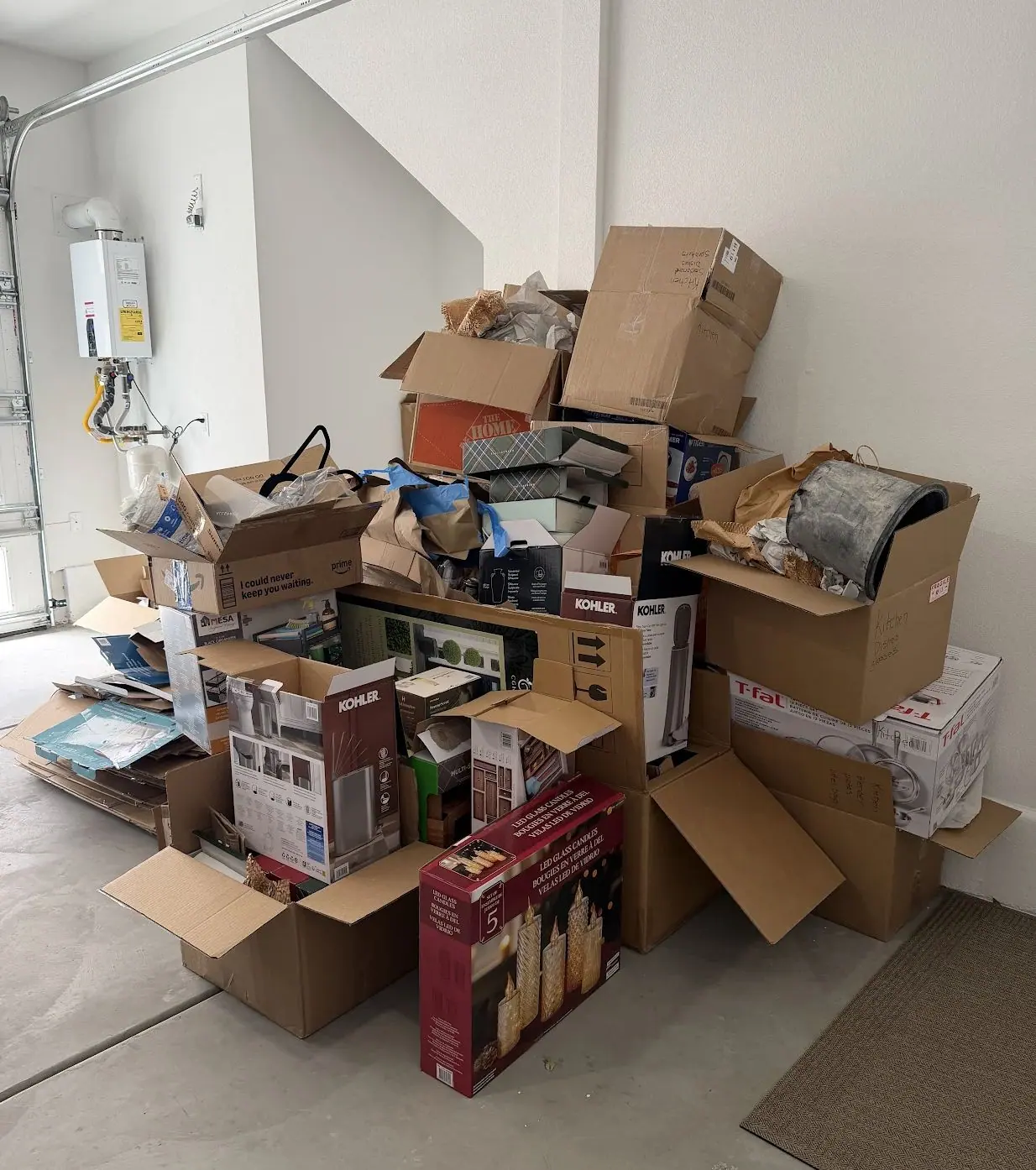 Empty moving boxes, packing paper and product cartons piled in a Henderson garage after unpacking