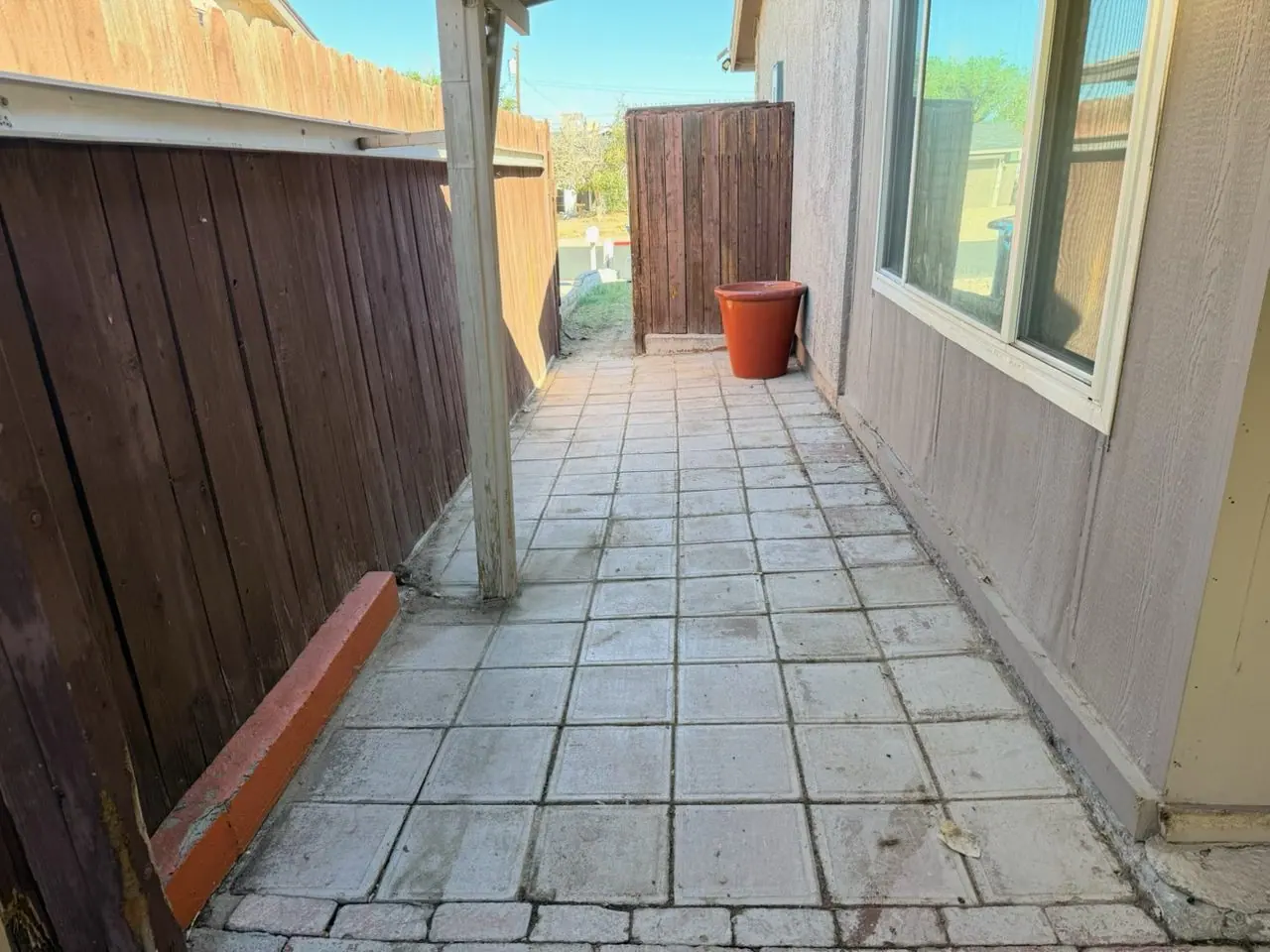 Same Downtown Henderson side yard walkway cleared of old fence debris