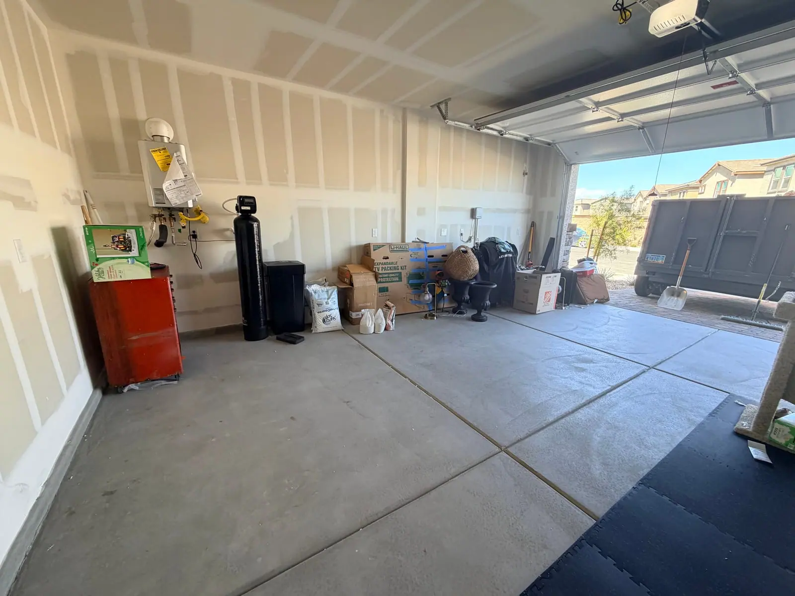 Same Inspirada garage emptied and broom swept, with only the homeowner's belongings left along the wall